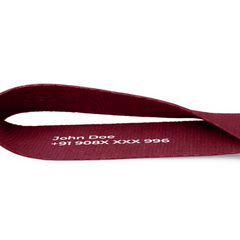 Maroon keychain strap with name and phone number printed
