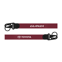Two red straps with 'Glanza' and 'Toyota' logos on a white background