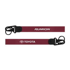 Two red lanyards with 'Rumion' and 'Toyota' logos on a white background