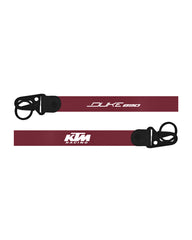 Two maroon straps with black buckles and KTM Racing branding on a white background
