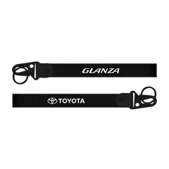 Two black lanyards with 'Glanza' and 'Toyota' logos on a white background