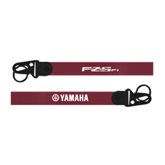 Two red straps with black buckles and logos on a white background