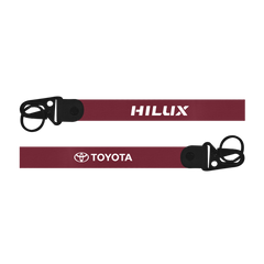 Maroon lanyard with 'HILUX' and 'TOYOTA' branding on a white background