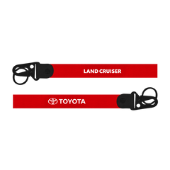 Red lanyard with 'Land Cruiser' and 'Toyota' branding on a white background