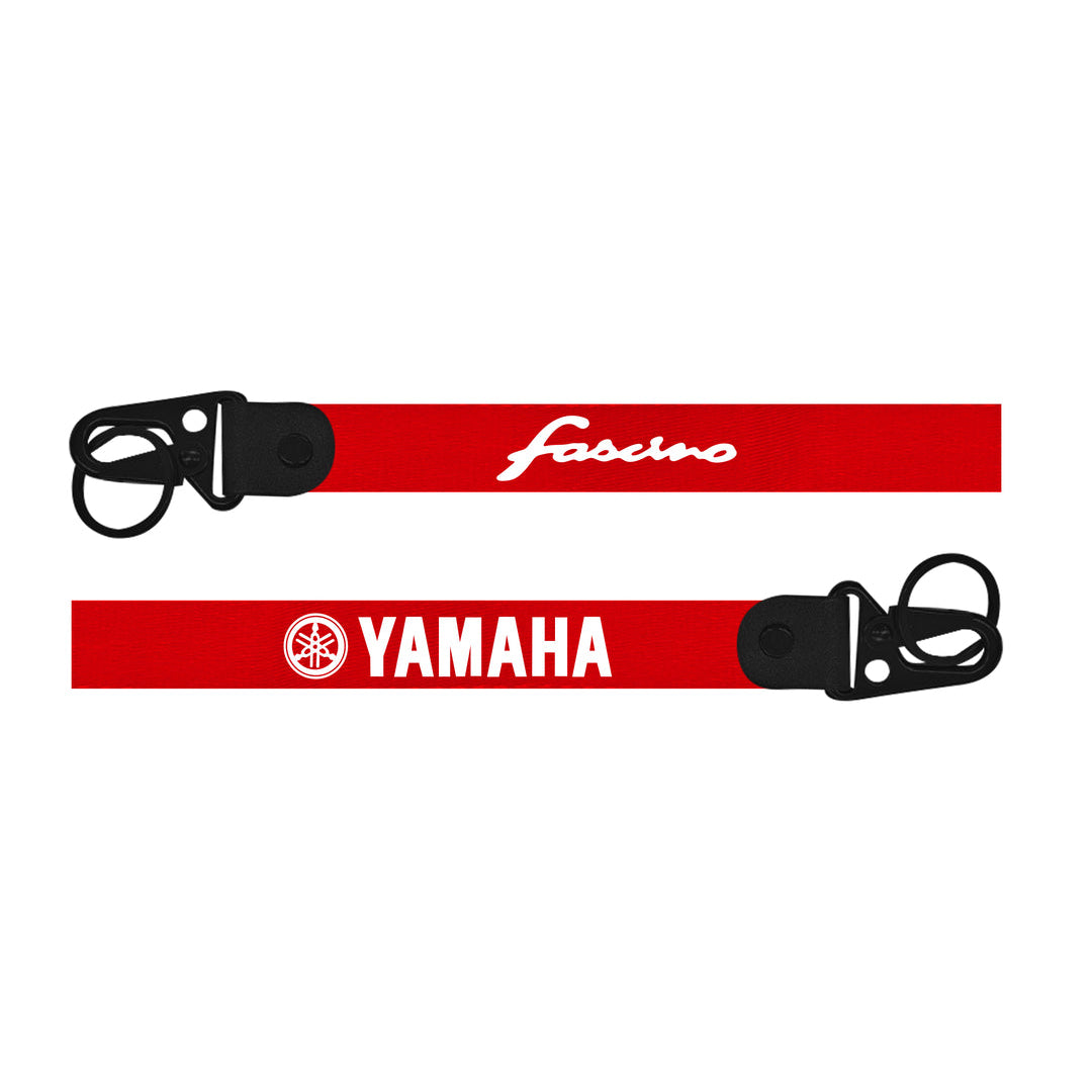 Two red straps with black buckles featuring 'Fasano' and 'Yamaha' logos on a white background.