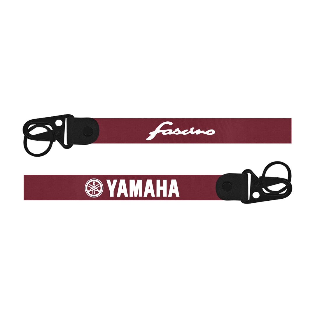 Two red straps with black buckles and logos on a white backgroundfasino  keychain