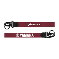 Two red straps with black buckles and logos on a white backgroundfasino  keychain